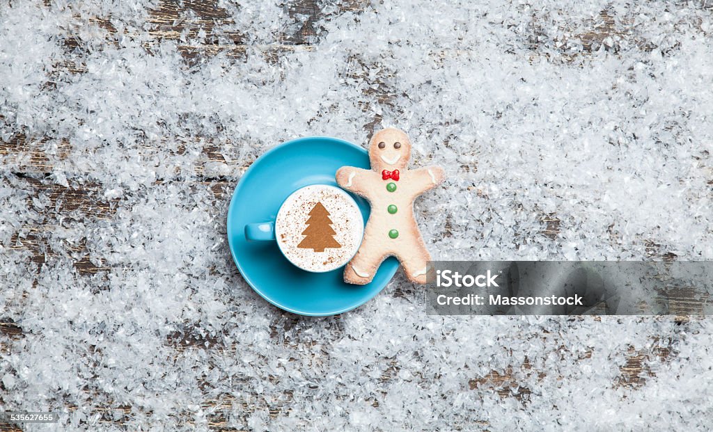 Cappuccino with christmas tree shape and gingerbread man on arti Cappuccino with christmas tree shape and gingerbread man on artificial snow background 2015 Stock Photo