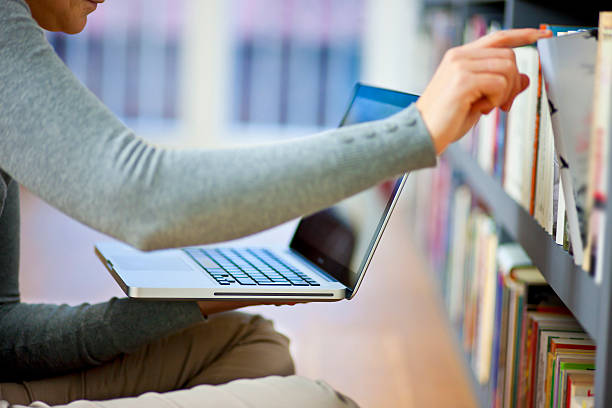 istock Young woman with laptop in home interior 535627715