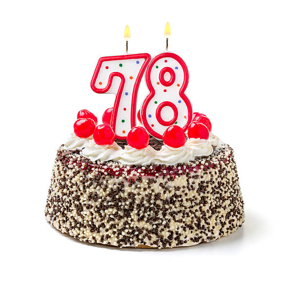 istock Birthday cake with burning candle number 78 535628475