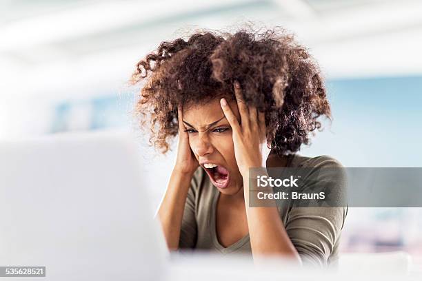 Angry African American Woman Using Computer Stock Photo - Download Image Now - Anger, Women, One Woman Only
