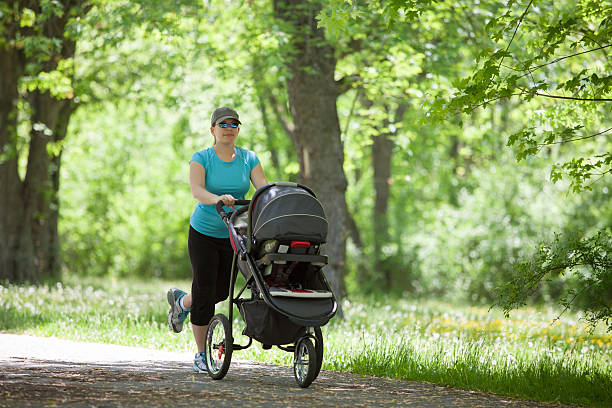 istock Young woman with a stroller 535630477