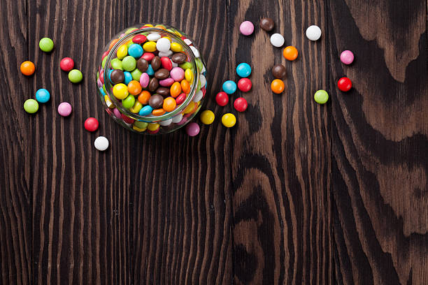 istock Colorful candies on wooden table 535632698