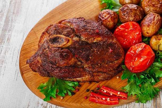 istock roasted pork shoulder on the bone with potatoes 535632949