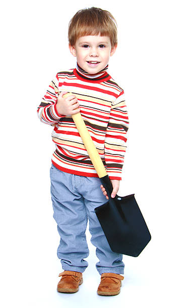 istock Little boy holding a large Sapper shovel 535634991