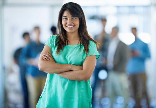 Portrait of a young office worker with her colleagues in the backgroundhttp://195.154.178.81/DATA/istock_collage/0/shoots/784748.jpg