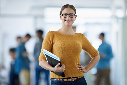 Portrait of a young office worker standing in an office with colleagues in the backgroundhttp://195.154.178.81/DATA/istock_collage/0/shoots/784748.jpg