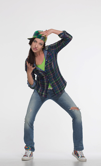 Portrait of street dancer in cap on white background