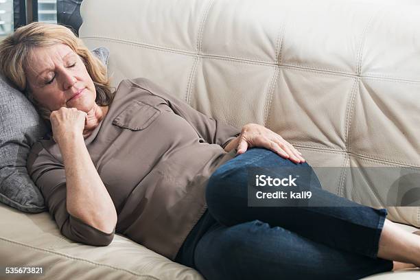 Senior Woman Asleep On The Couch Stock Photo - Download Image Now - Napping, Senior Women, Sofa