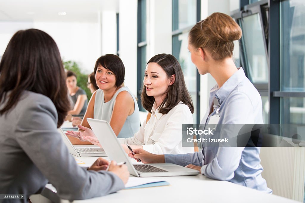 Job fair Group of women attending a job fair, working together and discussing. 2015 Stock Photo