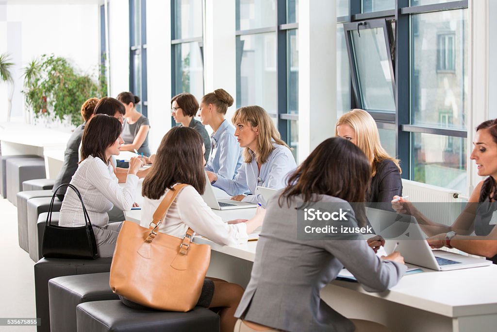 Large group of women at job fair Large group of women attending a job fair, working together and discussing in an office. Job Fair Stock Photo