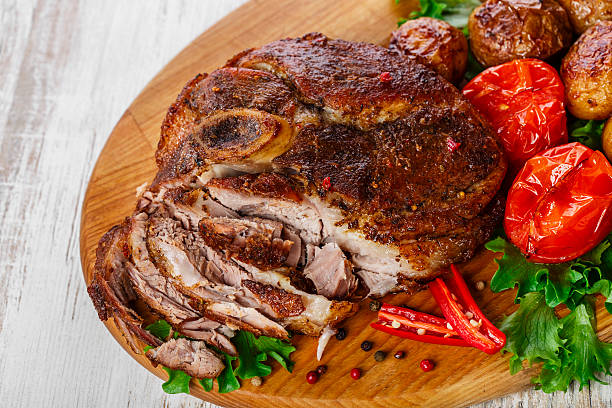 roasted pork shoulder on the bone with potatoes