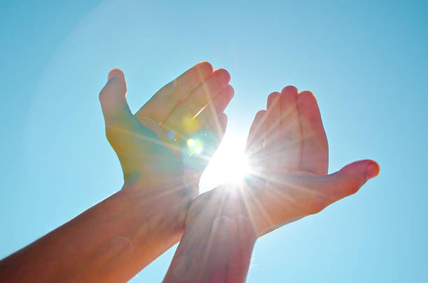 Life Energy Hands holding the sun with the blue sky background. reiki photos stock pictures, royalty-free photos & images