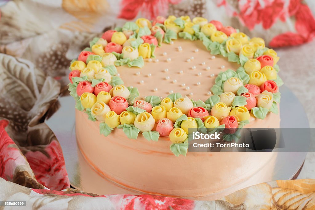 Cream cake decorated with small yellow and pink roses Homemade cream cake decorated with small yellow and pink roses 2015 Stock Photo