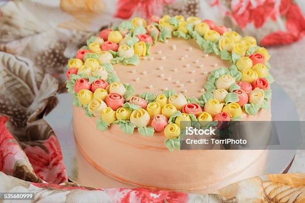 Cream Cake Decorated With Small Yellow And Pink Roses Stock Photo - Download Image Now