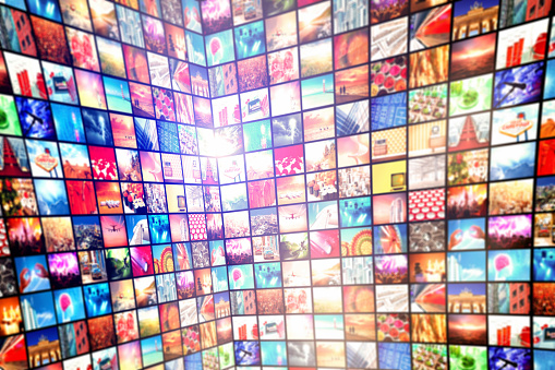 Digital photography archive showing a grid of multiple images arranged in rows. Multimedia background with hundrdeds, thousands of digital images filling a three dimensional space.