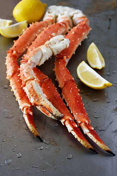 Red king crab legs Red king crab legs with lemon crab leg photos stock pictures, royalty-free photos & images