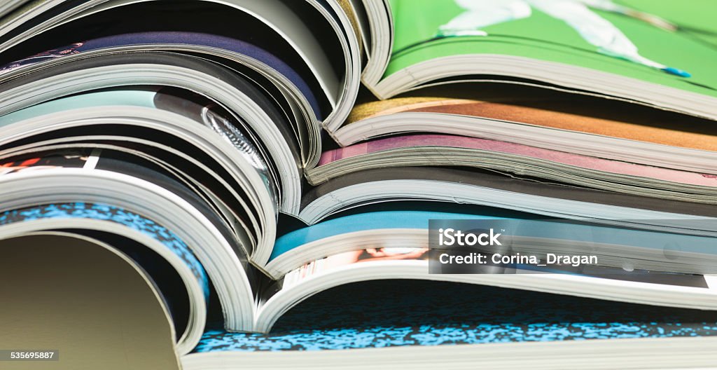 reading magazines stack of open magazines Reading Stock Photo
