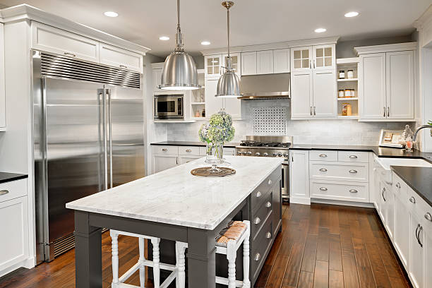 Beautiful Kitchen in Luxury Home with Island and Stainless Steel new furnished kitchen in luxury home kitchen worktop stock pictures, royalty-free photos & images