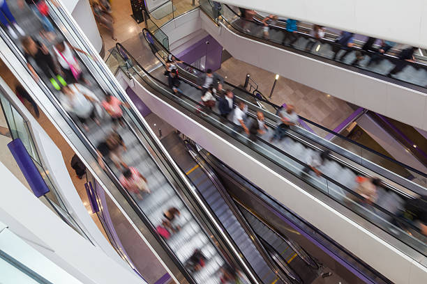 people in a shopping mall in motion blur