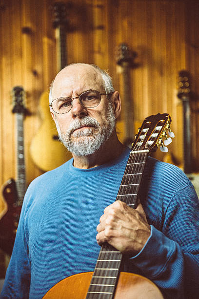 istock Guitar Shop Owner holding a classic guitar 535701913