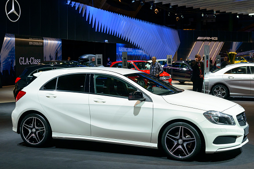 Brussels, Belgium - January 15, 2015: Mercedes Benz A Class hatchback car on display during the 2015 Brussels motor show. People in the background are looking at the cars.