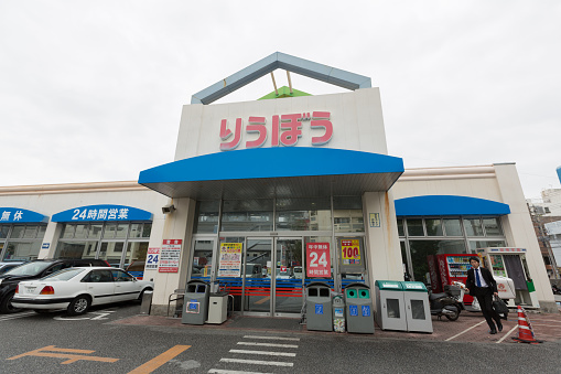 Naha, Japan - January 28, 2015 : A man walks past the Ryubo Supermarket in Naha, Okinawa, Japan. Ryubo Supermarket is a supermarket chainstore in Okinawa. 