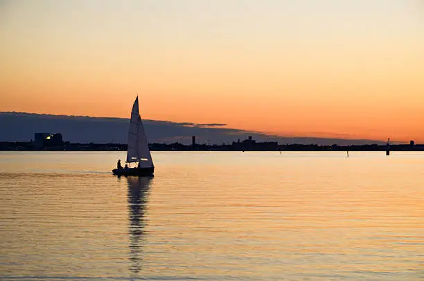 Sailing at evening with skyline of the city of Kalmar in Sweden i the horizon