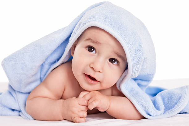 istock Cute gently baby lying on bed with blue towel 535717327