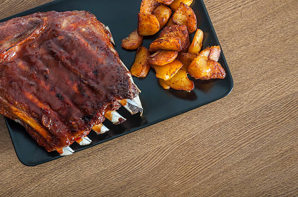 istock Barbecued honey ribs served with potatoes 535717433