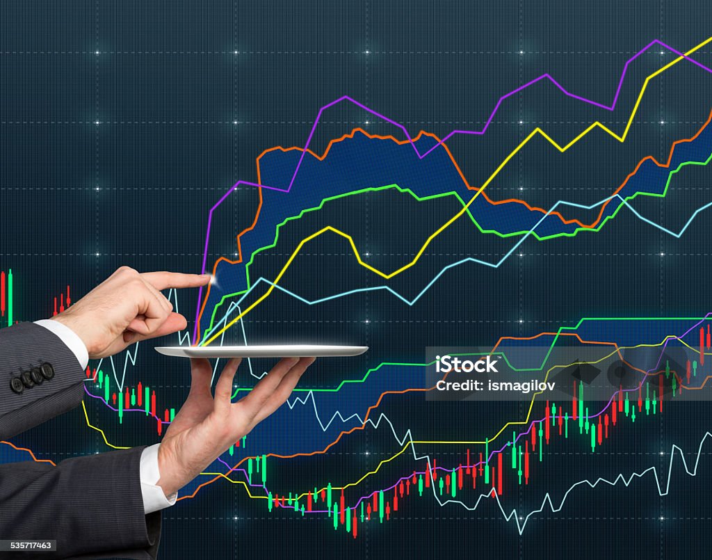 digital tablet with chart Hand holding digital tablet with chart  isolation on blue 2015 Stock Photo