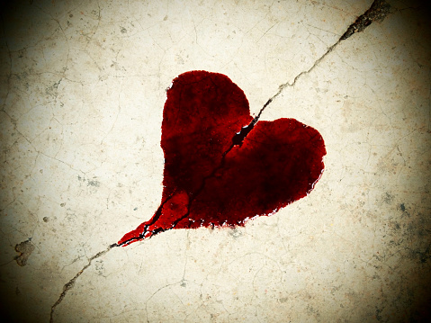 Red heart on concrete road