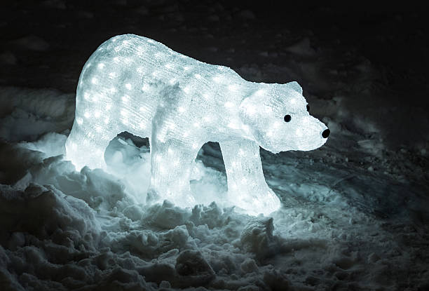 Bear made from garlands in snow and lights