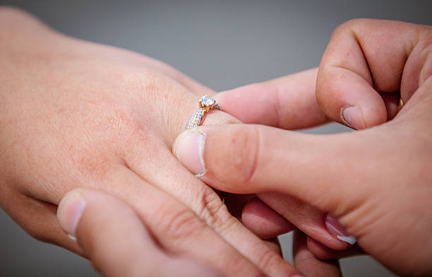 istock Man placing a diamond engagement ring 535723365