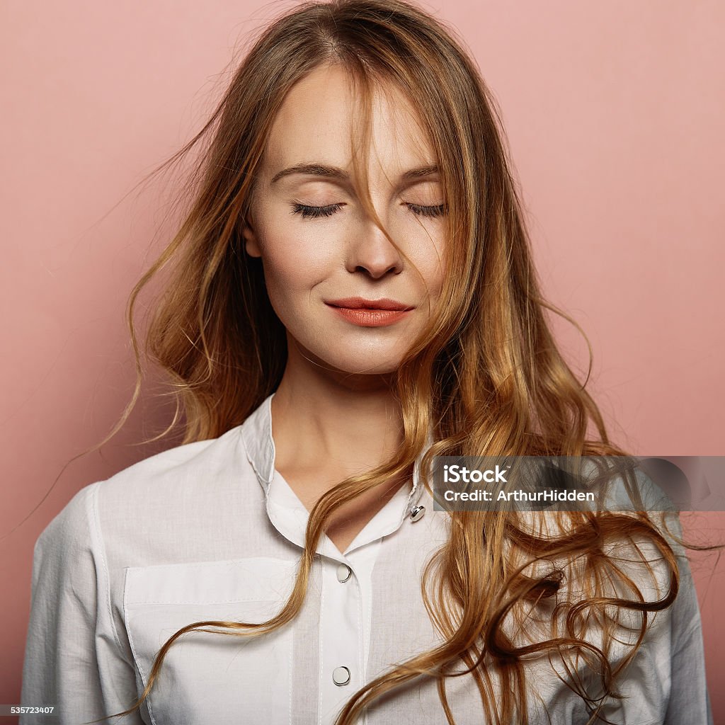 Attractive girl portrait in a white shirt Attractive girl portrait in a white shirt on a pink background 2015 Stock Photo