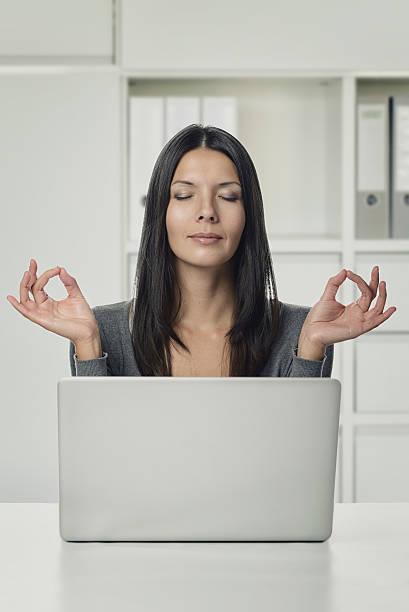 istock Pretty Woman Using Laptop with Yoga Hand Gestures 535723471