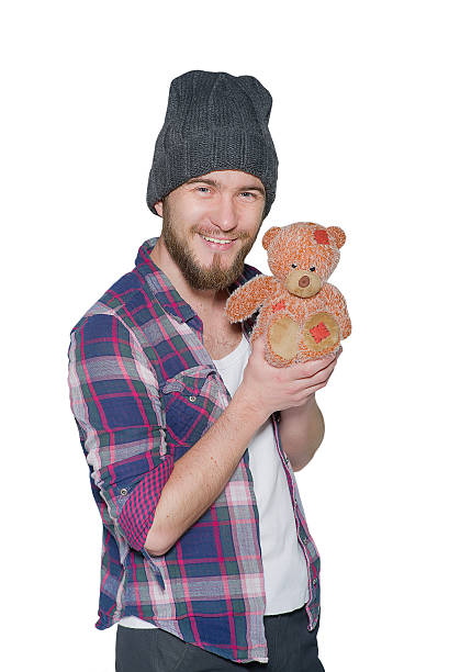 istock Smiling young man with teddy bear isolated on white background 535724125