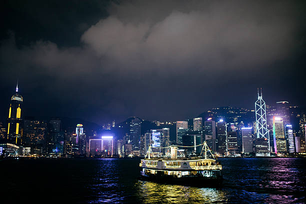 A view of the Star Ferry sailing across Victoria Harbour at night, Hong Kong. 