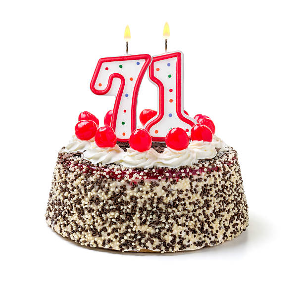 istock Birthday cake with burning candle number 71 535725665
