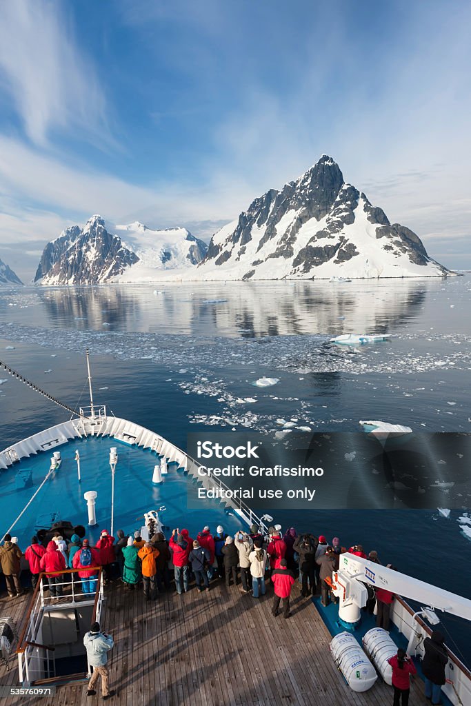 Antartica tourists on ship driving through Lemaire Channel Half Moon Island, Antarctica - January, 17th 2013: Group of tourists driving on ship through the Lemaire Channel observing the landscape Antarctica Stock Photo