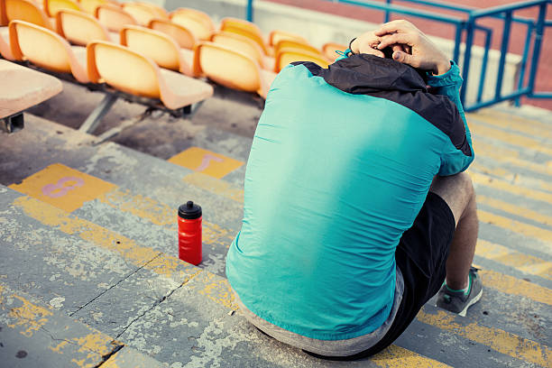 istock tired sportsman sitting on the stadium 535763159