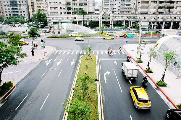 view from above of the traffic-filled city street with many yellow taxis and cars that look like little models