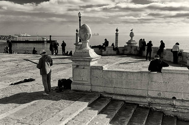 Lisbon, Portugal - January 13, 2015: A street musician plays his electric guitar in the Praça do Comércio square in Lisbon downtown.