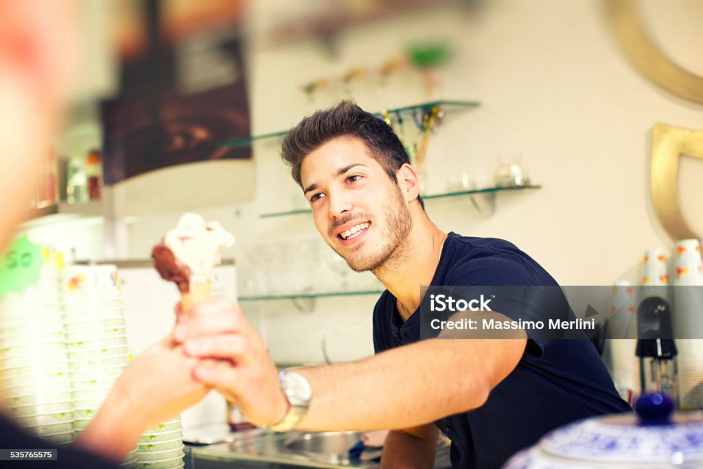 Barman serving a ice cream to customer Ice Cream Parlor Stock Photo