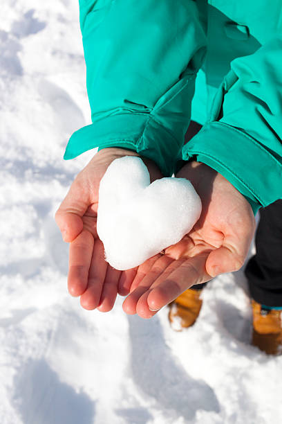 istock Female hands showing snow heart 535769197
