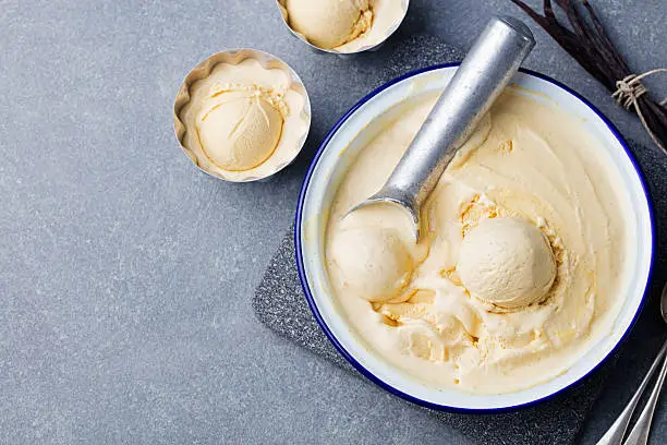 Photo of Homemade vanilla, caramel ice cream in vintage bowl Organic product