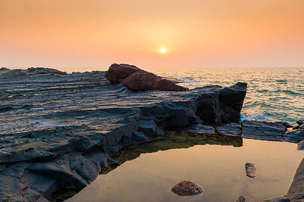 istock hardened lava and ocean at sunset 535769643
