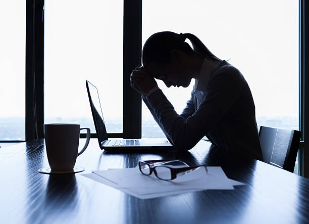 Stressed businesswoman Silhouette of stressed businesswoman in the office. frustration stock pictures, royalty-free photos & images