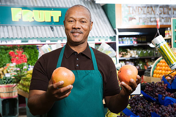 greengrocer - supermarket sales clerk grocer apron ストックフォトと画像