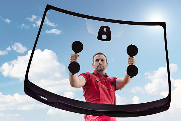 Car Mechanic Man working in a garage windshield stock pictures, royalty-free photos & images