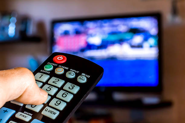 istock Hand hold the remote control to change channels on Tv 535772906